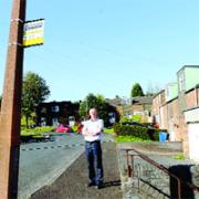 ELDERLY SUFFER: Whitewell ward councillor Jim Pilling by the discontinued bus stop, on the Foxhill Drive estate, in Whitewell Bottom
