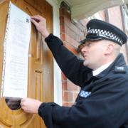 ACTION: Sgt Mark Cruise puts up the notice