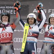 RYDING HIGH: Dave Ryding (above, centre) celebrates his historic win in Kitzbuehel with Lucas Braathen (left) and Henrik Kristoffersen (right)