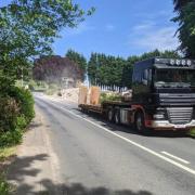 A lorry driving away from the site of the demolished Punch Bowl Inn in Hurst Green