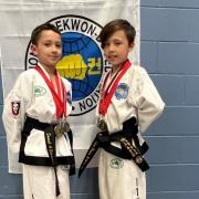 Samuel Edmondson and Adam Berisha after winning gold medals at a taekwondo competition in April