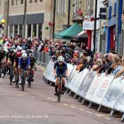 TALK OF THE TOWN: Riders riding through the town centre during the Colne Grand Prix watched by thousands of spectators Pictures: VeloUk