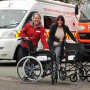 The Red Cross receive wheelchairs donated by the Gannett Foundation to Alison Foy and Sarah Collins