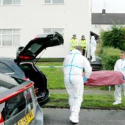 MURDER HOUSE: Police remove a body from the house in Waddington Avenue where the deaths occurred