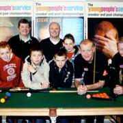 MASTERCLASS: Steve Davis, second from right, with Coun Perks, third left, with Paul Thomas and Phil Harrison and members of the youth group on their visit to Squires snooker club, Lancaster