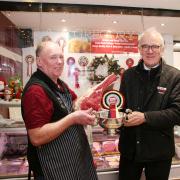 Phil Gregory is pictured left with a cut of the shop’s supreme champion prime beef and the trophy that goes with it, presented by Skipton Auction Mart’s general manager and auctioneer Jeremy Eaton.