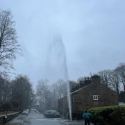 Water has been shooting out of a burst pipe in Helmshore.