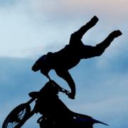 SPECTACULAR A trick motorcyclist flies over a 70ft gap 45ft in the air