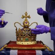 Cadbury World chocolatiers Dawn Jenks and Donna Oluban add the finishing touches to a 45cm tall chocolate replica of St Edward's Crown at Cadbury World in Birmingham.