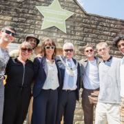 The cast and crew from Greatest Days, including director Coky Giedroyc and the actors and dancers who play the boy band, helped Ribble Valley Mayor Mark Hindle (middle) unveil a gold star at Clitheroe Market