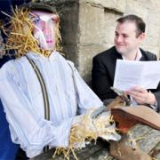 VILLAGE ALIVE! Pendle MP Andrew Stephenson, one of the judges, with the cobbler scarecrow at Four Alls Inn.