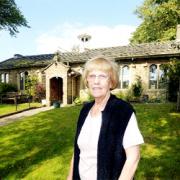 ambitious Higham Village Hall chairman Eileen Knight and the building which is being renovated