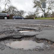A series of potholes on a stretch of road