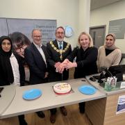 Mayor of Pendle Cllr Brian Newman celebrating Specsavers fifth anniversary in Colne with staff