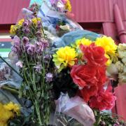 Flowers left at the scene in Kulsuma Akter's memory