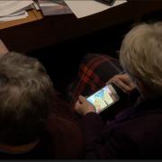 Cllr Lishman apparently playing Candy Crush on her mobile phone in a council meeting