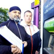 ‘COMMUNITY ASSET’ Mahmood Bawa, left, and Max Cowburn with the petition to keep the cash machine