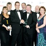 winning TEAM David Hill presents the award to Andrew Buchanan, surrounded by his ‘fantastic’ colleagues