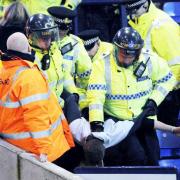 A fan is arrested at Tuesday's match