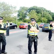 Officers arrive to witness the travellers leaving