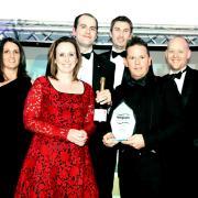 Gareth Frankland (second from right), CEO of acdc LED, collects the award