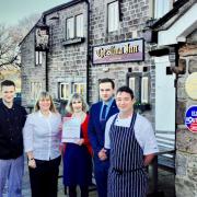 Tina Griffiths from Les Routiers, centre, presents staff and managers from The Alma Inn with their latest accolade