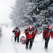 Paul and fellow members of the team carry an injured casualty through the snow