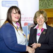 Lyndsey receives her award from Chief Guide Gill Slocombe.