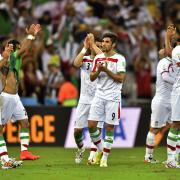 Iranian players applaud the crowd after the group F World Cup soccer match between Iran and Nigeria at the Arena da Baixada in Curitiba, Brazil