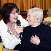 Singer Joyce Kay of Blackburn, is joined on the mike by 89 year old Kathleen Heys of Darwen, during the Good Friends afternoon at Derwent Hall, Darwen.