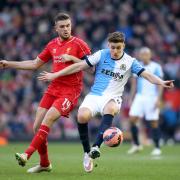 Tom Cairney battles with Liverpool captain Jordan Henderson