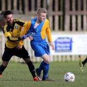 HELD: Barnoldswick Town’s Joel Melia is stopped in his tracks and his side are now facing a nervous final day of the season