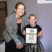 Alisha Cowell, the Primary School Pupil of the Year award winner at last year's Schools Awards accepts her prize from Belinda Logan,