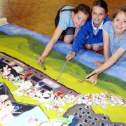 ENTHUSIASTIC: Leah Spalding, eight, Tess Gazzard, ten, and Joy Maddock, nine, with the school’s mural