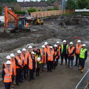 BUSY: VIPs get a look at the freshly cleared site as the Shadsworth Hub project enters the construction phase