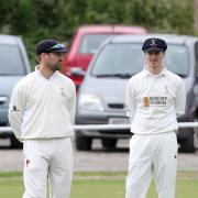 BAND OF BROTHERS: David Brown (left) chats to brother Michael in the outfield during Sunday’s Worsley Cup semi-final win over Lowerhouse