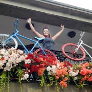 PEDAL POWER: Charly Randle on the balcony of the Duke of Lancaster pub, now festooned with painted bicycles.