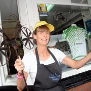 PEDAL POWER: Deborah Gowans, of CJ’s Coffee Shop, Whalley, shows off the cycle-themed window and flower pot