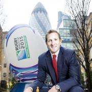 EDITORIAL USE ONLY
Former England Rugby Union player Will Greenwood, holds the Web Ellis Cup in front of a four metre high rugby ball in London's Devonshire Square to announce that Rugby World Cup 2015 Travel & Hospitality packages will be going on sale