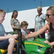 Alfie Reynolds with mum, Katie Curson with a mini tractor
