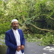 Cllr Hussain Akhtar, who represents the area on Blackburn with Darwen Council, stood infront of the large tree