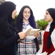 GCSE results day at Blackburn Central high School. From left, Amirah Bhamji, Kiran Khan and Mariam Sidat discuss where they are going next.