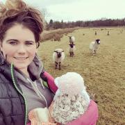 Georgie Mitchell with some of her sheep and her new ‘baby’ Peggy