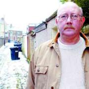 DRIVE: Coun Roy Davies in one of the Sudell back streets where he would like to see alley gates