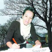 SUPPORT US: Parent Sylvia Clark signs the petition outside Hapton Primary Schoo