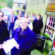 PETITION: Graham Wilkinson and the Venerable John Hawley with local residents outside Chipping's threatened post office