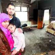 SAFE: Coun Arshid Mahmood with his wife and young daughter who escaped the blaze