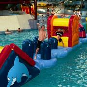 Young swimmers enjoy the inflatable Fun Night at Blackburn Waves