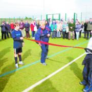 A CUT ABOVE: Hockey legend Val Robinson cuts the ribbon to official open the new hockey pitch