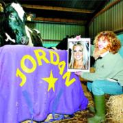 CELEBRITY STATUS: Farm worker Fiona Houghton shows a picture of Jordan to her namesake Jordan the cow